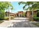 Elegant single-Gathering home with a clay tile roof, stone accents, gated entrance and lush landscaping at 1813 Boyce St, Sarasota, FL 34239