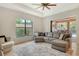 Bright living room featuring a comfortable sectional sofa, large window and access to the screened lanai at 1813 Boyce St, Sarasota, FL 34239