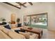 Open living room design with coffered ceilings, stone fireplace, and access to the outdoor patio at 1813 Boyce St, Sarasota, FL 34239