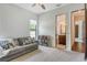 Inviting living room area with a gray couch, bright pillows, and a view into the bathroom at 1813 Boyce St, Sarasota, FL 34239