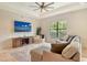 Comfortable living room with large windows, neutral colors, and an entertainment center with TV at 1813 Boyce St, Sarasota, FL 34239