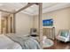 Spacious primary bedroom features a tray ceiling, sitting area, wood floors, and a flatscreen TV at 1813 Boyce St, Sarasota, FL 34239