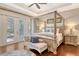 Primary bedroom with tray ceiling, four-poster bed, and direct access to the screened pool area at 1813 Boyce St, Sarasota, FL 34239