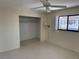 Bright bedroom featuring a ceiling fan, large closet, and view of the outdoor pool at 191 Maria Ct, Punta Gorda, FL 33950