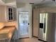 Kitchen view with stainless steel refrigerator and uniquely patterned glass door to outside at 191 Maria Ct, Punta Gorda, FL 33950