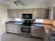 Updated kitchen with stainless steel appliances, light cabinets, and spacious countertops at 191 Maria Ct, Punta Gorda, FL 33950