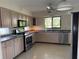 Bright kitchen with stainless steel appliances, light wood cabinets and a sunlit window at 191 Maria Ct, Punta Gorda, FL 33950