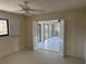 View of a bright room with open doors to sunroom, a window, and a ceiling fan at 191 Maria Ct, Punta Gorda, FL 33950