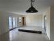 Spacious living area with large windows, patterned area rug, and decorative light fixture at 191 Maria Ct, Punta Gorda, FL 33950