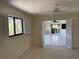 Light-filled living room with windows and open bi-fold doors leading to the sunroom and pool area at 191 Maria Ct, Punta Gorda, FL 33950