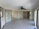 A light filled living room with tiled floors and multiple sliding glass doors at 191 Maria Ct, Punta Gorda, FL 33950