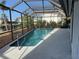 Inviting pool area enclosed for year-round enjoyment, offering refreshing water and a serene canal backdrop at 191 Maria Ct, Punta Gorda, FL 33950
