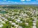 An aerial view of a residential neighborhood with mature trees, ponds and blue skies at 1915 38Th W St, Bradenton, FL 34205