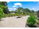 Landscaped backyard featuring light gravel, various shrubbery, and newly planted trees at 1915 38Th W St, Bradenton, FL 34205