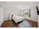Bedroom features wood floor, ceiling fan, and side tables with lamps at 1915 38Th W St, Bradenton, FL 34205