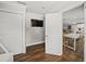 Open dining area featuring wood floors, white table with seating and a view into the kitchen at 1915 38Th W St, Bradenton, FL 34205