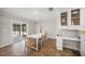 Dining room featuring a white table, sliding door to lanai, and built-in cabinets and desk at 1915 38Th W St, Bradenton, FL 34205