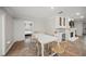 Dining area featuring a white table and view of a bunk room and white-painted brick fireplace at 1915 38Th W St, Bradenton, FL 34205