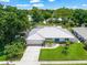 An aerial view of a single Gathering home with mature landscaping and a blue front door at 1915 38Th W St, Bradenton, FL 34205