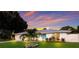Lovely home boasts curb appeal with a lush lawn and a vibrant, welcoming entrance at 1915 38Th W St, Bradenton, FL 34205