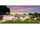 Beautiful single-story home featuring a well-manicured lawn and a striking blue front door at 1915 38Th W St, Bradenton, FL 34205