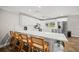 Bright kitchen with white cabinetry, stainless appliances, and a large kitchen island with bar seating at 1915 38Th W St, Bradenton, FL 34205