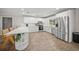 Bright white kitchen featuring stainless steel appliances and large center island with decorative shelving at 1915 38Th W St, Bradenton, FL 34205