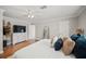 Spacious main bedroom with wood flooring, large dresser, TV, and an ensuite bathroom at 1915 38Th W St, Bradenton, FL 34205