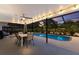 Cozy outdoor patio with a dining set, string lights, and a view of the refreshing pool at 1915 38Th W St, Bradenton, FL 34205