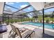 Relaxing screened-in pool area with patio seating and lush landscaping at 1915 38Th W St, Bradenton, FL 34205