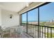 Relax and enjoy the view from this balcony with black railings and comfortable white wicker seating at 2045 Gulf Of Mexico Dr # M1-515, Longboat Key, FL 34228