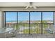 Enjoy the ocean view from this screened balcony with wicker furniture and beautiful tile flooring at 2045 Gulf Of Mexico Dr # M1-515, Longboat Key, FL 34228