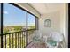 Enjoy the treetop views from this cozy screened balcony with seating at 2045 Gulf Of Mexico Dr # M1-515, Longboat Key, FL 34228