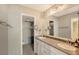 Bright bathroom with dual sinks, granite counters, walk-in closet and neutral color palette at 2045 Gulf Of Mexico Dr # M1-515, Longboat Key, FL 34228