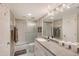Clean bathroom featuring a shower-tub combination, ample storage space, and neutral decor at 2045 Gulf Of Mexico Dr # M1-515, Longboat Key, FL 34228