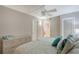 Comfortable bedroom with light gray walls and a view through to another room at 2045 Gulf Of Mexico Dr # M1-515, Longboat Key, FL 34228