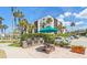 Outdoor grilling area featuring built-in grills and picnic tables, perfect for entertaining guests with palm tree views at 2045 Gulf Of Mexico Dr # M1-515, Longboat Key, FL 34228