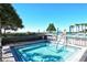 Community hot tub with metal rail, fence and ocean view on a sunny day at 2045 Gulf Of Mexico Dr # M1-515, Longboat Key, FL 34228