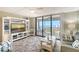 Relax in this comfortable living room with a coastal view and balcony access for ocean breezes at 2045 Gulf Of Mexico Dr # M1-515, Longboat Key, FL 34228