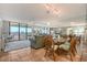 Bright living and dining area with tile floors, floor-to-ceiling mirrors, and balcony access at 2045 Gulf Of Mexico Dr # M1-515, Longboat Key, FL 34228