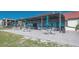Exterior of clubhouse with covered patio, tables, chairs, pavers, lawn and ocean view at 2045 Gulf Of Mexico Dr # M1-515, Longboat Key, FL 34228