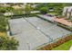 Overhead view of multiple tennis courts with well-maintained greenery and nearby parking, ideal for recreational enjoyment at 2045 Gulf Of Mexico Dr # M1-515, Longboat Key, FL 34228