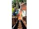 View of the backyard from an elevated wooden staircase with a colorful storage shed at 219 24Th W St, Bradenton, FL 34205