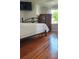 Bedroom features hardwood floors, a black iron bed, and a wood dresser at 219 24Th W St, Bradenton, FL 34205