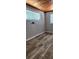 Bedroom view with wood-look floors, striped wallpaper, and natural light at 219 24Th W St, Bradenton, FL 34205