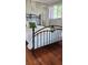 Cozy bedroom boasts hardwood floors, an iron bed, and a serene window view at 219 24Th W St, Bradenton, FL 34205