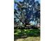 Beautiful two-story home with mature trees and a green lawn at 219 24Th W St, Bradenton, FL 34205