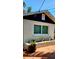 Rear exterior view showcasing window and well-maintained landscaping along the side of the house at 219 24Th W St, Bradenton, FL 34205
