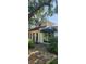 Charming home exterior with arched entryway, black awning, and well-kept landscaping at 219 24Th W St, Bradenton, FL 34205