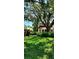 Beautifully landscaped front yard with mature trees offering plenty of shade at 219 24Th W St, Bradenton, FL 34205